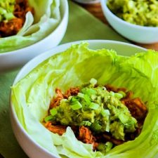 Slow Cooker Barbecue Chicken shown in lettuce wraps with guacamole