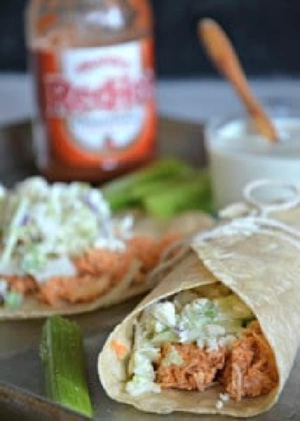Slow Cooker Buffalo Chicken Tacos with Blue Cheese Slaw from Mountain Mama Cooks with tacos, red hot sauce, and blue cheese in photo