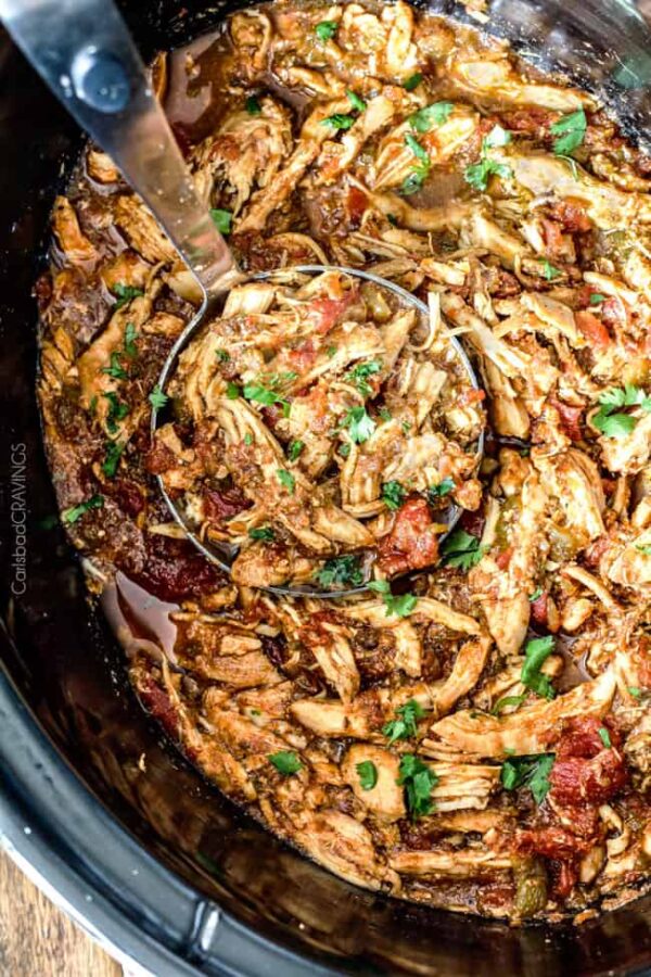 Easy Slow Cooker Mexican Shredded Chicken from Carlsbad Cravings shown in crockpot