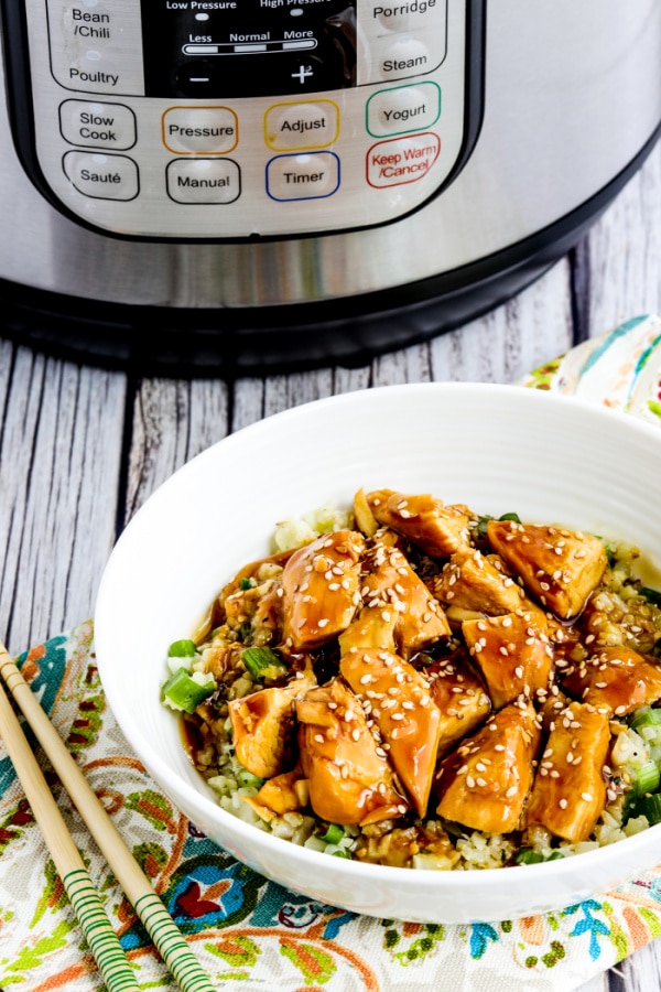 Instant Pot Teriyaki Chicken with Teriyaki Chicken rice bowl shown in front of Instant Pot