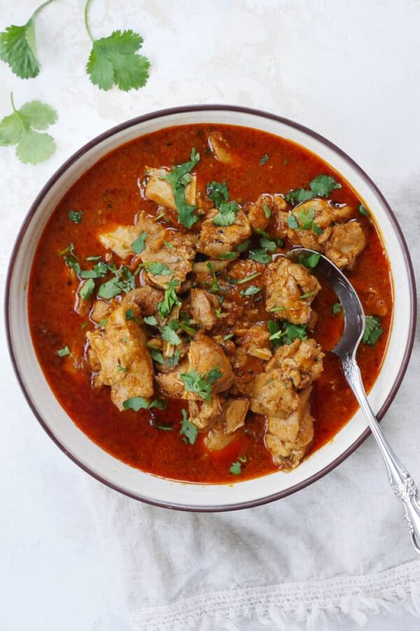 Instant Pot Chicken Vindaloo from My Heart Beets shown in bowl with spoon.