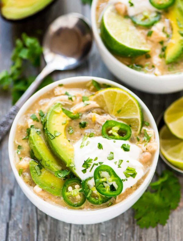 Crockpot White Chicken Chili from Well Plated by Erin shown with avocado and Jalapenos.