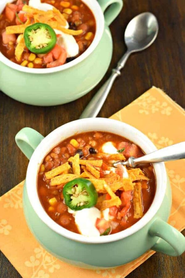 Slow Cooker Vegetarian Lentil Tortilla Soup from Shugary Sweets in green bowls.
