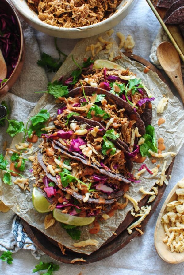 Slow Cooker Pulled Pork Crunchy Tacos from Bev Cooks shown on platter.