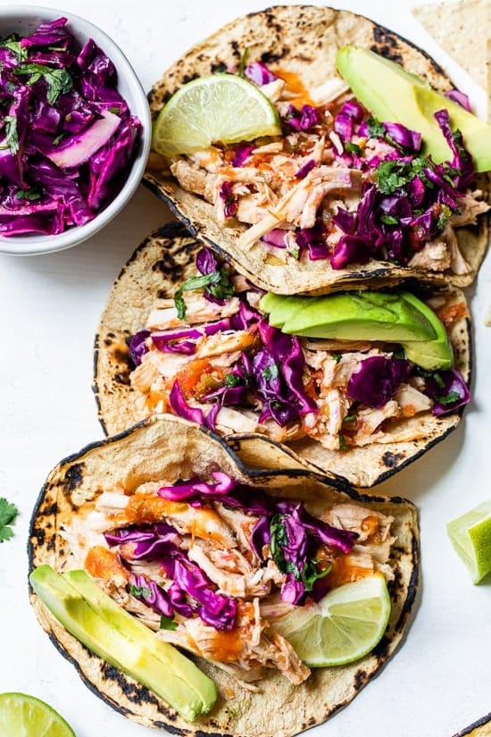 Slow Cooker Chicken Tacos from Skinnytaste shown with three tacos on plate.