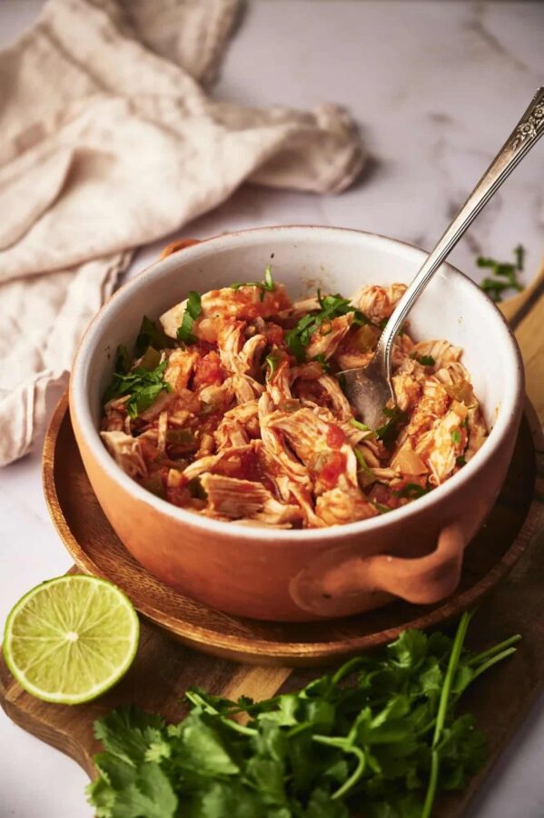 Chicken Tinga from Slender Kitchen shown in serving bowl with spoon.