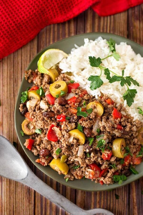 Instant Pot Picadillo from Simply Happy Foodie shown on plate with rice.
