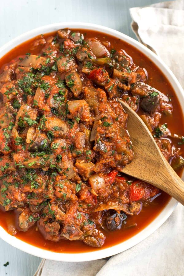 Slow Cooker Ratatouille from Easy Cheesy Vegetarian shown in bowl with serving spoon.
