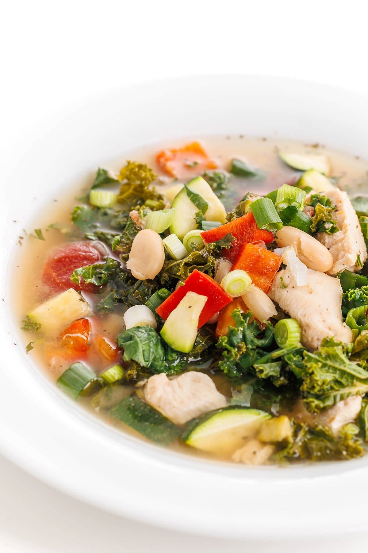 Slow Cooker Italian Chicken Soup shown in white bowl.