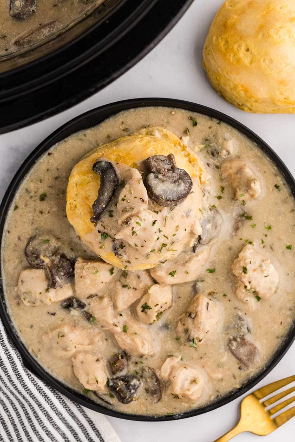 Slow Cooker Chicken and Gravy shown on serving plate.