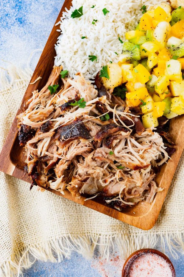 Slow Cooker Kalua Pork from Oh Sweet Basil shown on serving board.