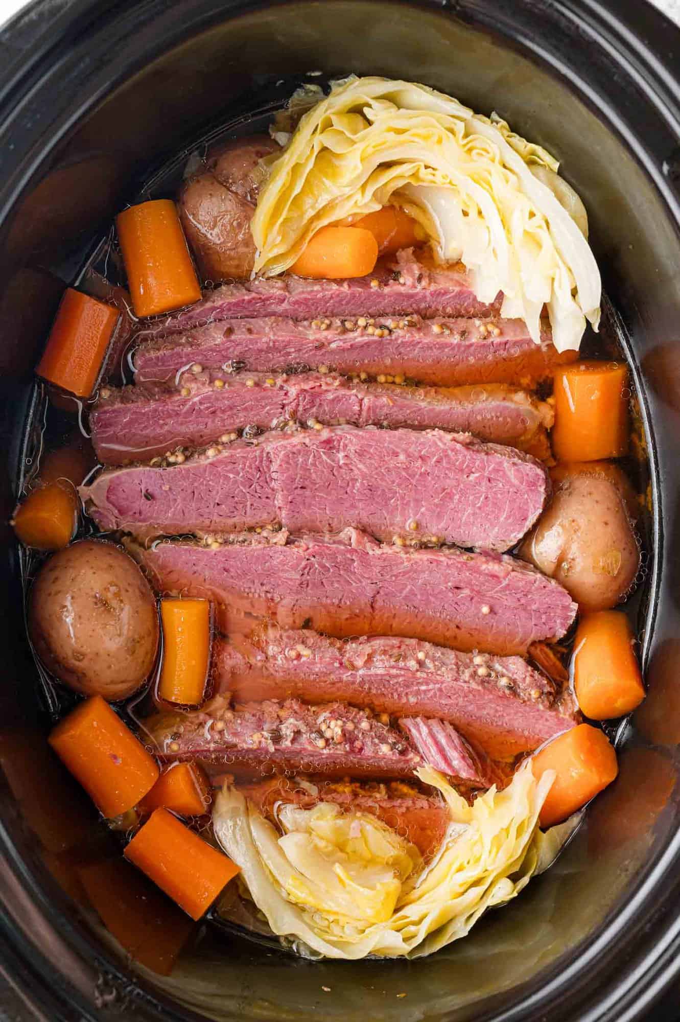 Slow Cooker Corned Beef and Cabbage from Rachel Cooks shown in crockpot.